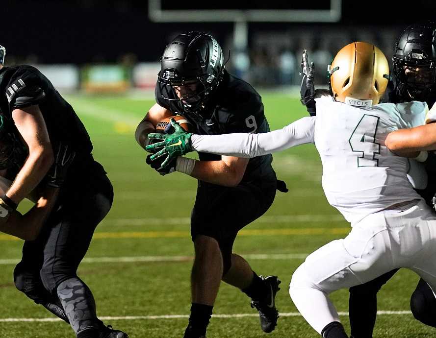 Casey Filkins runs for one of his four touchdowns Friday night against Jesuit. (Photo by Jon Olson)