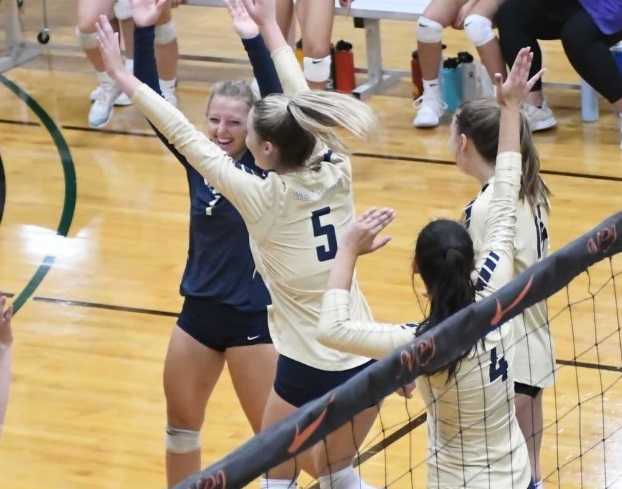 Sydney Backer (1) and Madie Dowell (5) celebrate a West Albany point. (Photo by Ed McReynolds)