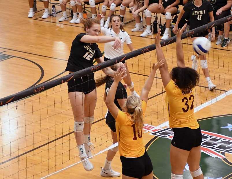 Jesuit's Alyssa Hughes hits over Central Catholic's Tennison Brady-Steen (10) and Bella Scarlett (32). (Photo by Ed McReynolds)