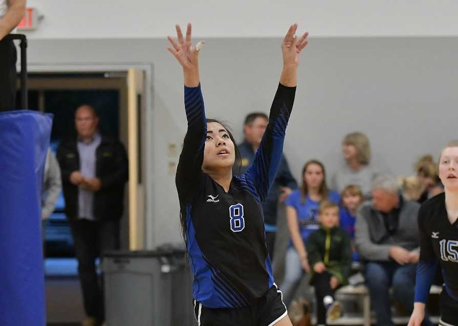 Willamette Valley Christian's Delaney Barnes sets against Falls City. (Photo by Andre Panse)