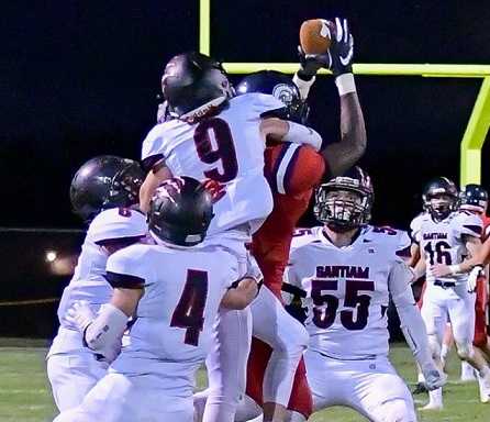 Linebacker Dustin Keys (55) and the Santiam defense swarmed Kennedy's Emorej Lynk. (Photo by Andre Panse)