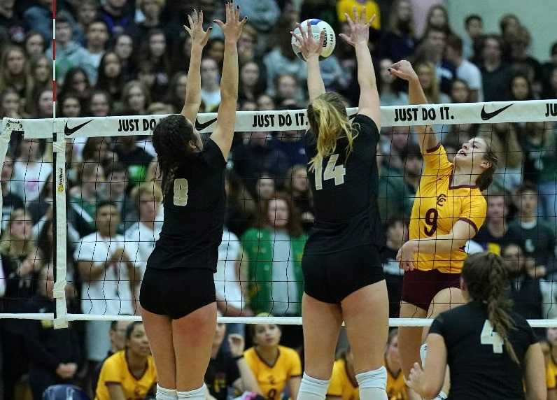 Jesuit's Maddy Dowdall (8) and Ella Masingale (14) block Central Catholic's Katie Nall (9). (Photo by Jon Olson)