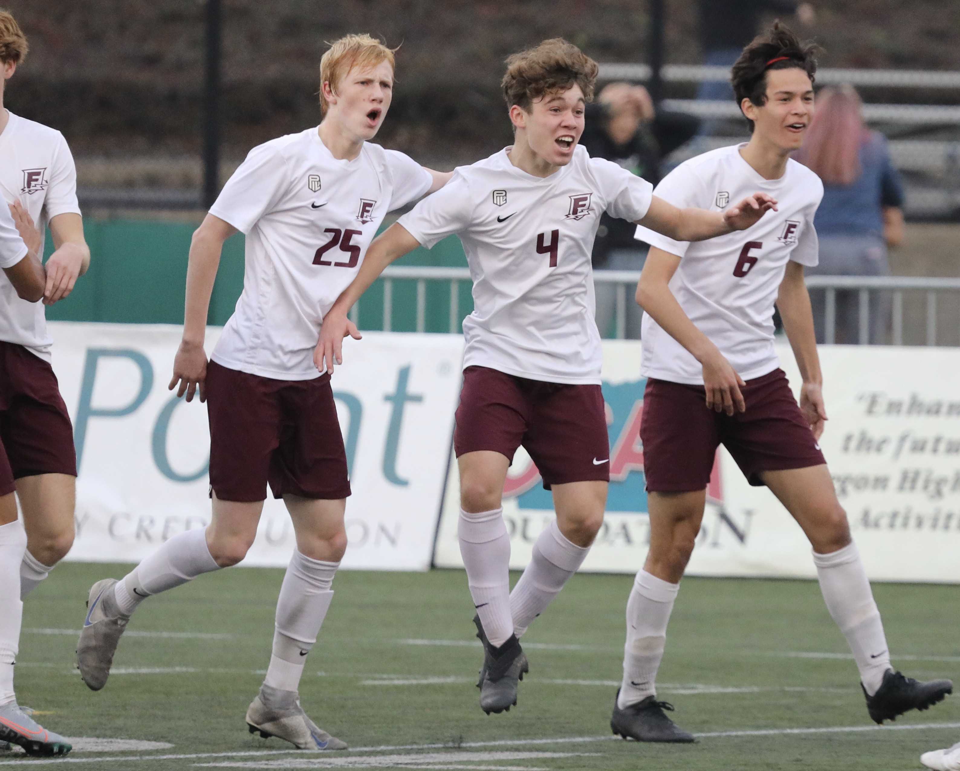 Franklin's Riley Reisner (4) celebrates his team's first goal with teammates Caden Davis (25) and Felix Moren. (Norm Maves Jr.)