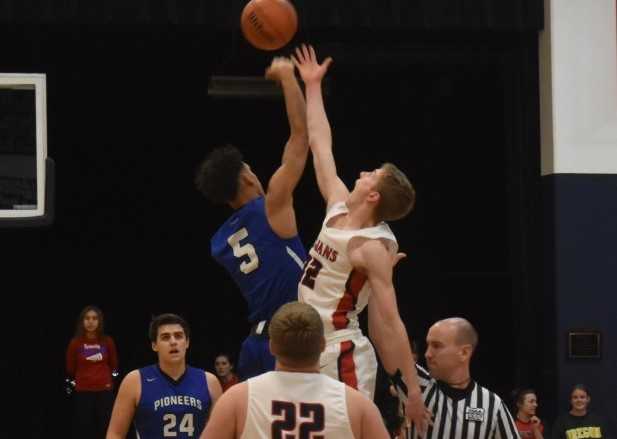 Western Christian's Payton Richardson (5) jumps against Kennedy's Luke Hall. (Photo by Jeremy McDonald)