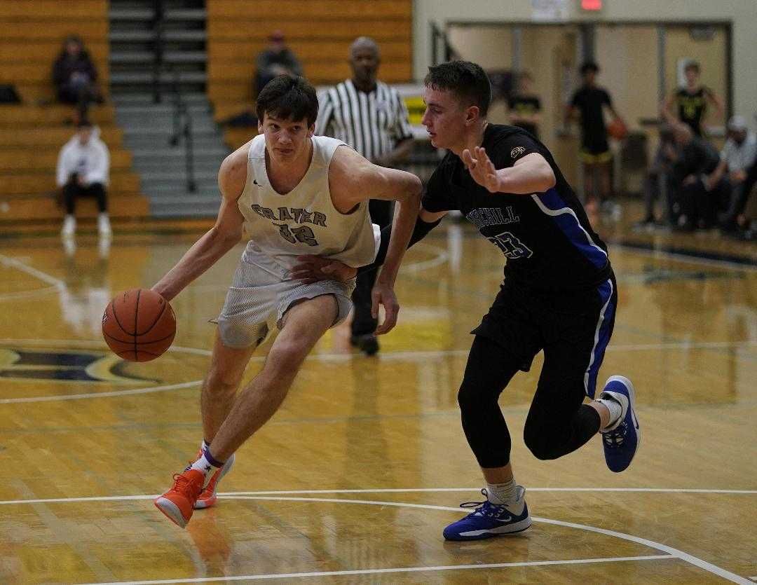 Crater's Nate Bittle drives around Churchill's Brian Goracke on Monday at the Les Schwab Invitational. (Photo by Jon Olson)