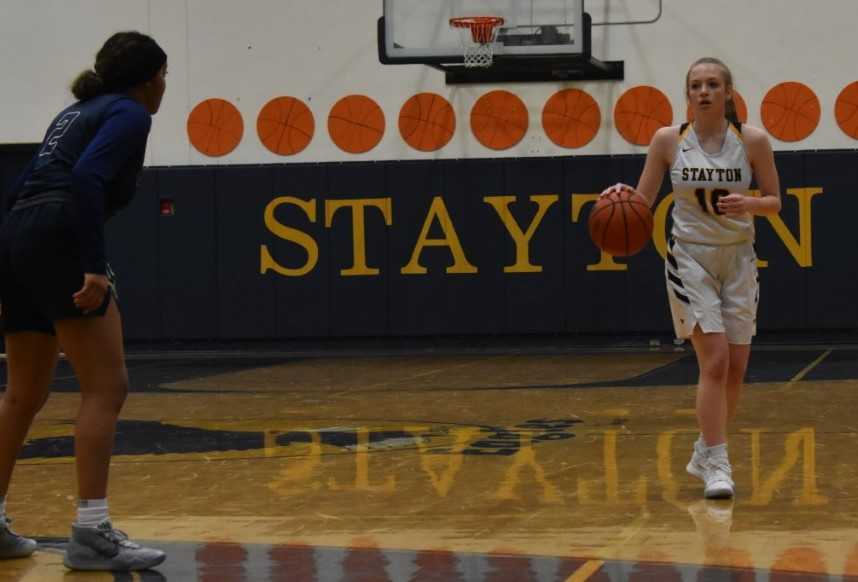 Stayton's Emma Storey brings the ball up the court against Mannahouse Christian's Marlei Knox. (Photo by Jeremy McDonald)