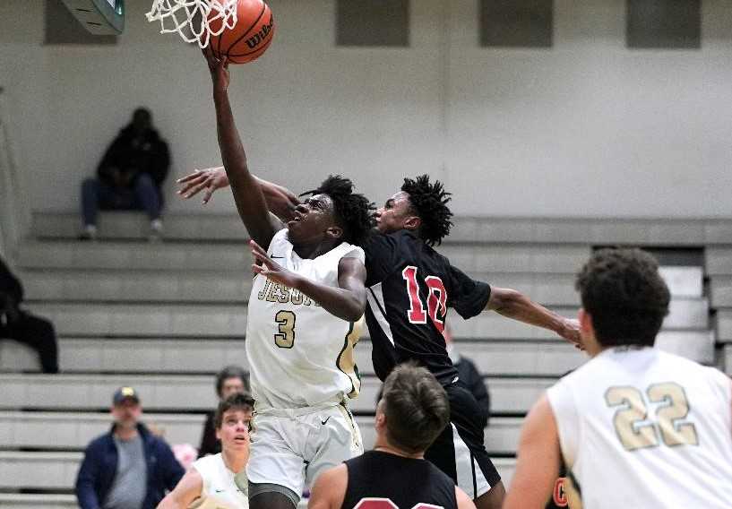 Jesuit's Roy Bunn (3) goes up for two points against Clackamas' KJ Horsley. (Photo by Jon Olson)