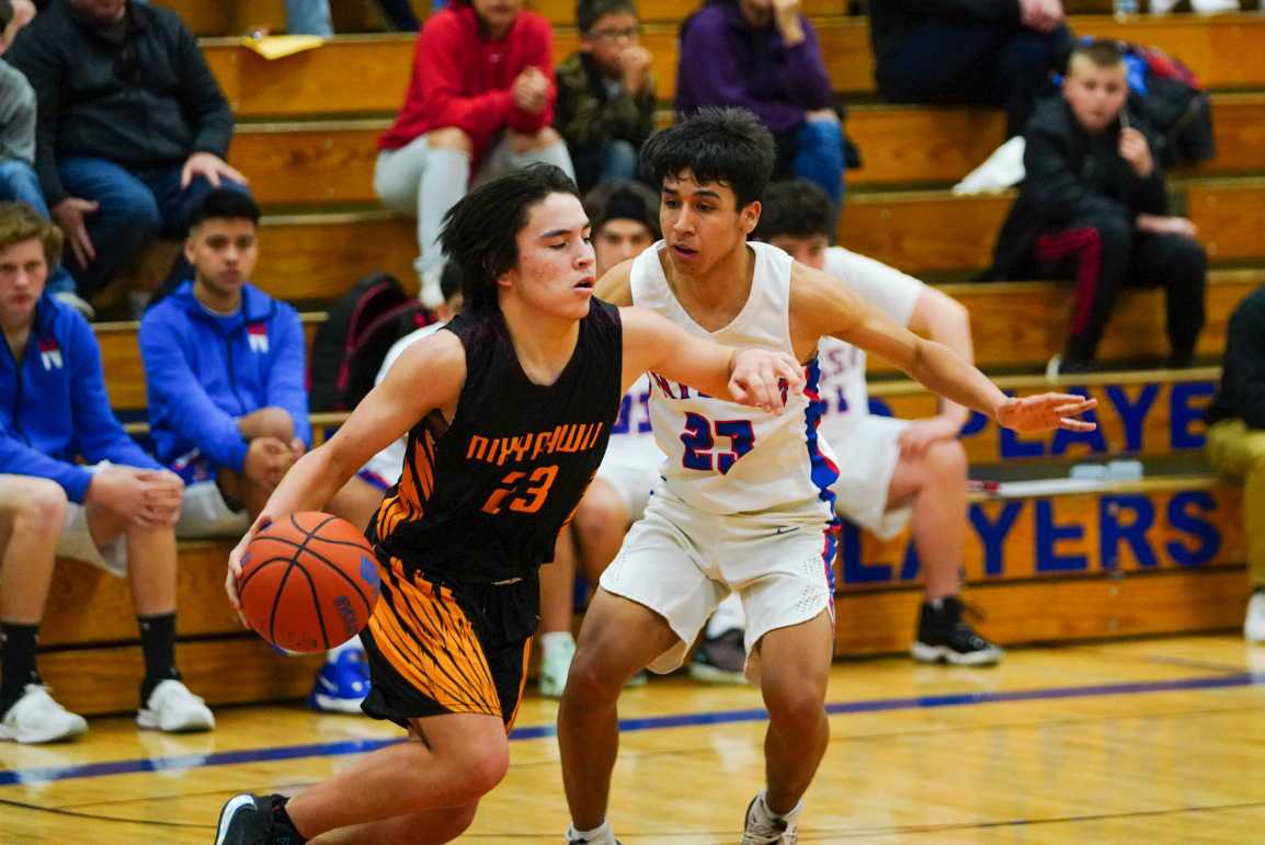 Nixyaawii's Tyasin Burns (23) drives against Nyssa's Pedro Chavez on Monday. (Randy Seals/Eastern Oregon Sports Photos)