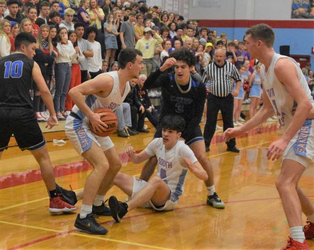 South Salem's Kieran Pruett snags a loose ball against McNary on Saturday night. (Photo by Jeremy McDonald)