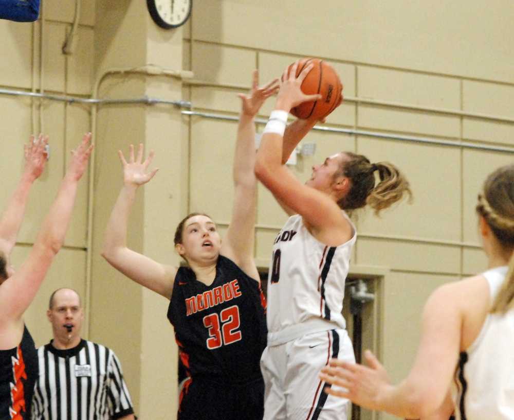 Kennedy senior Sophia Carley scores two of her game-high 20 over Monroe's Callie Horning