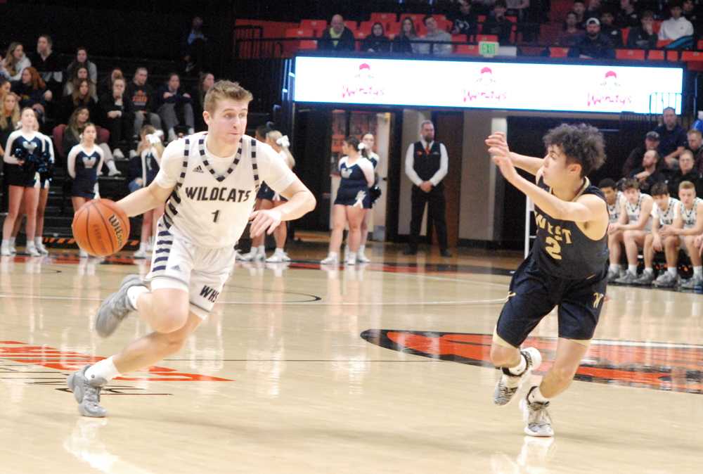 Wilsonville point guard Gabe Reichle drives on West Albany's Koby Ruiz. Reichle had 11 first-half points in the Wildcat win