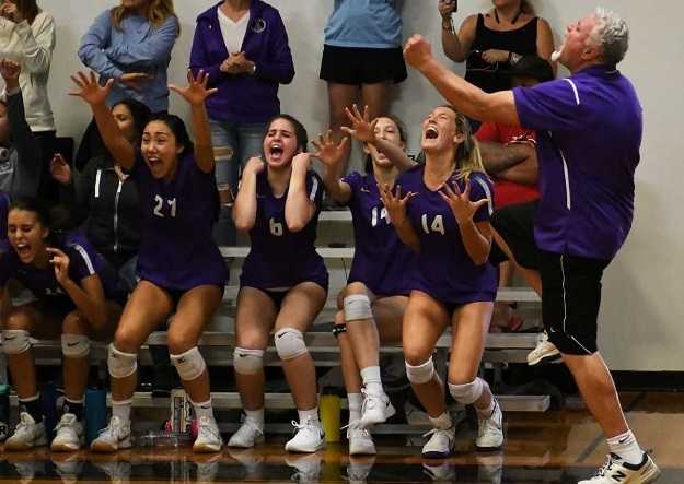 Sunset coach Lad Salness and his players celebrate a point against Central Catholic. (Photo by Ed McReynolds)