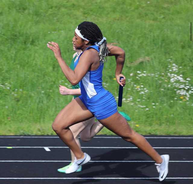 Mary Gach steams around the far turn at the state meet her junior year. Photo by Sam Hull