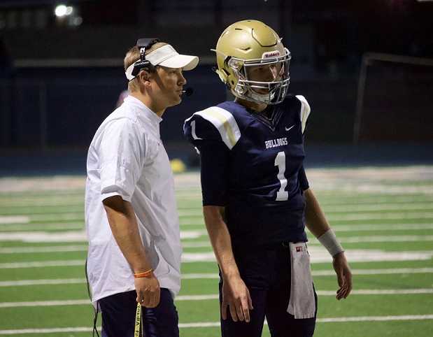 Junior quarterback Carson Van Dyke (1), with receivers coach Derek Duman, is making strides of late. (Photo by Kylie Wagar)