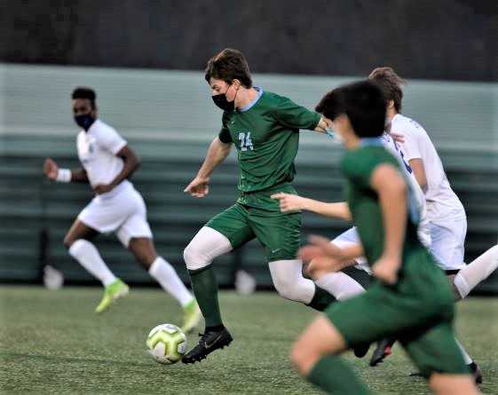 Oregon Episcopal's Connor Mansfield (24) pushes up the field against Catlin Gabel. (Photo by John Holloran)