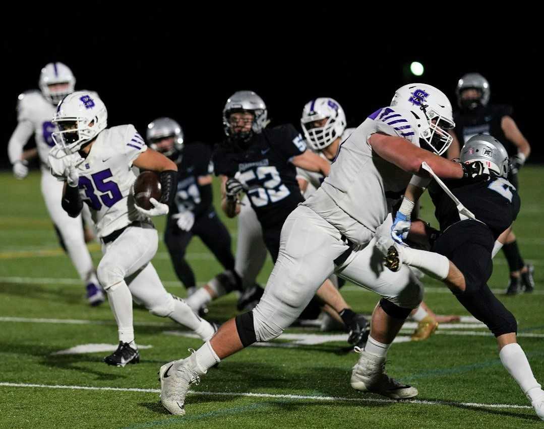 Sunset's Caleb Kim (35) breaks free up field as Liam Brown (right) clears the way Friday night. (Photo by Jon Olson)