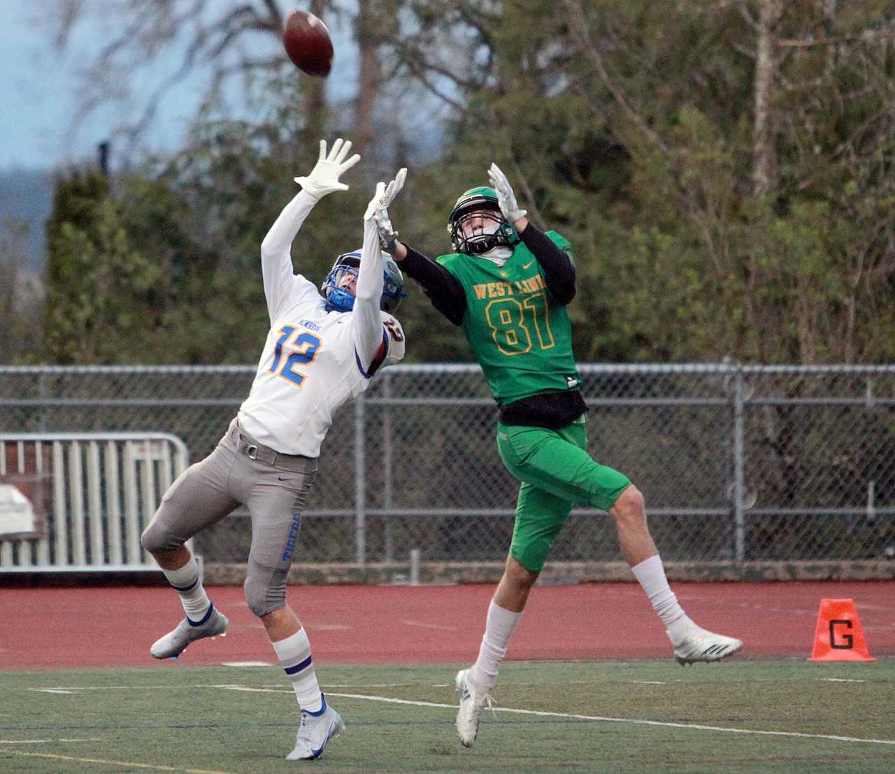 West Linn's Aiden Scott (81) goes up for a touchdown catch against Newberg's Gavin Korkeakoski (12). (Miles Vance/Pamplin Media)