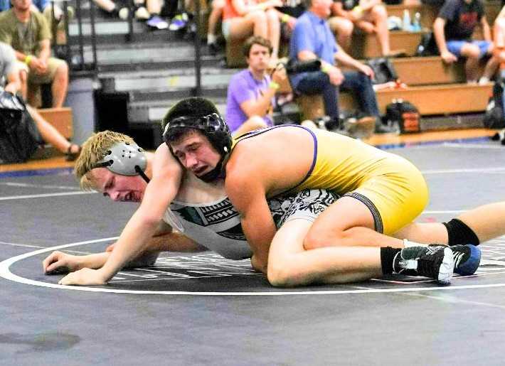 Newberg's Charlie Evans (right), against Century's Will Musser, was one of five Tiger champions. (Photo by Jon Olson)