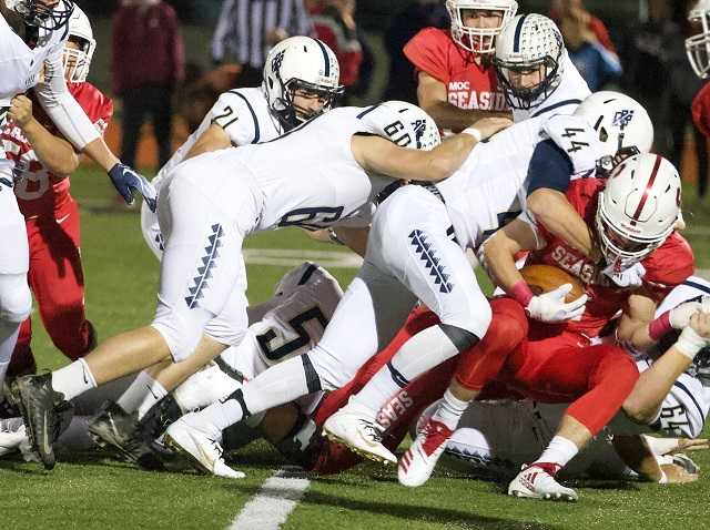 Banks defenders Hayden Gobel (44), Tyler Exline (60), Josiah Ochoa (21) and Risdon White team up to stop Alexander Teubner.