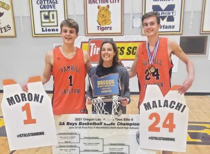 Heather, Moroni and Malachi Seely-Roberts celebrate after Yamhill-Carlton won the 3A culminating week tournament.