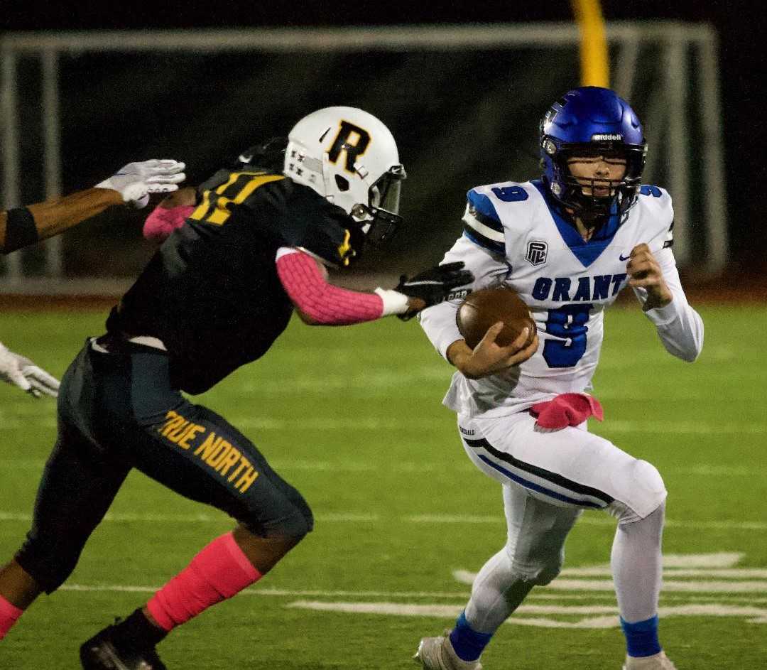 Grant quarterback Kellen Segel tries to elude from Roosevelt's MyQuis Fesser on Friday night. (Photo by Noah Peterson)