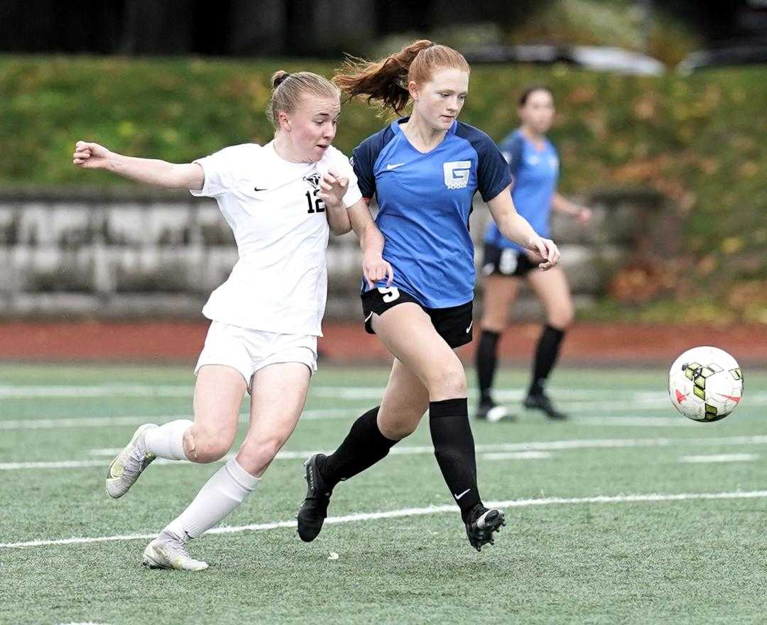 Grant's Caprial Loescher (9), battling with Lincoln's Aimee Poole (12), scored a goal in Friday's 2-0 win. (Photo by Jon Olson)