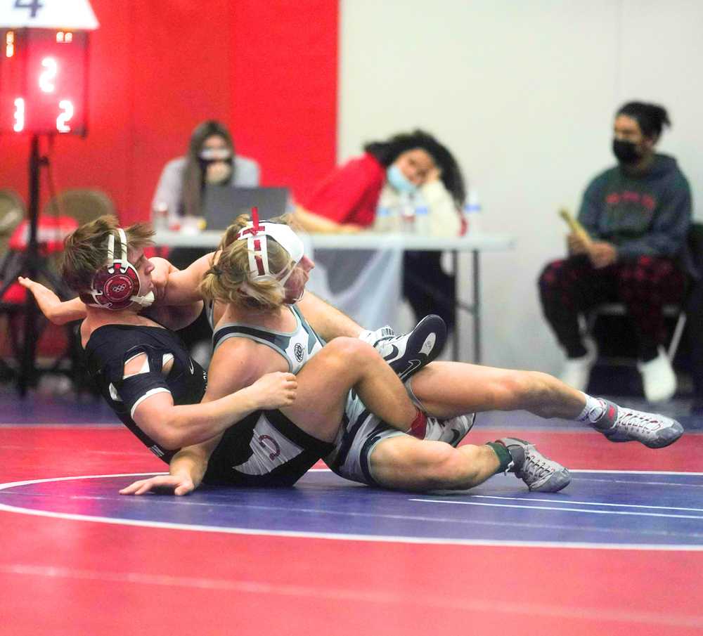 Thurston junior Kolton Malone, left, won a close match to win the 145-pound title at the Rose City Invitational (Jon Olson)