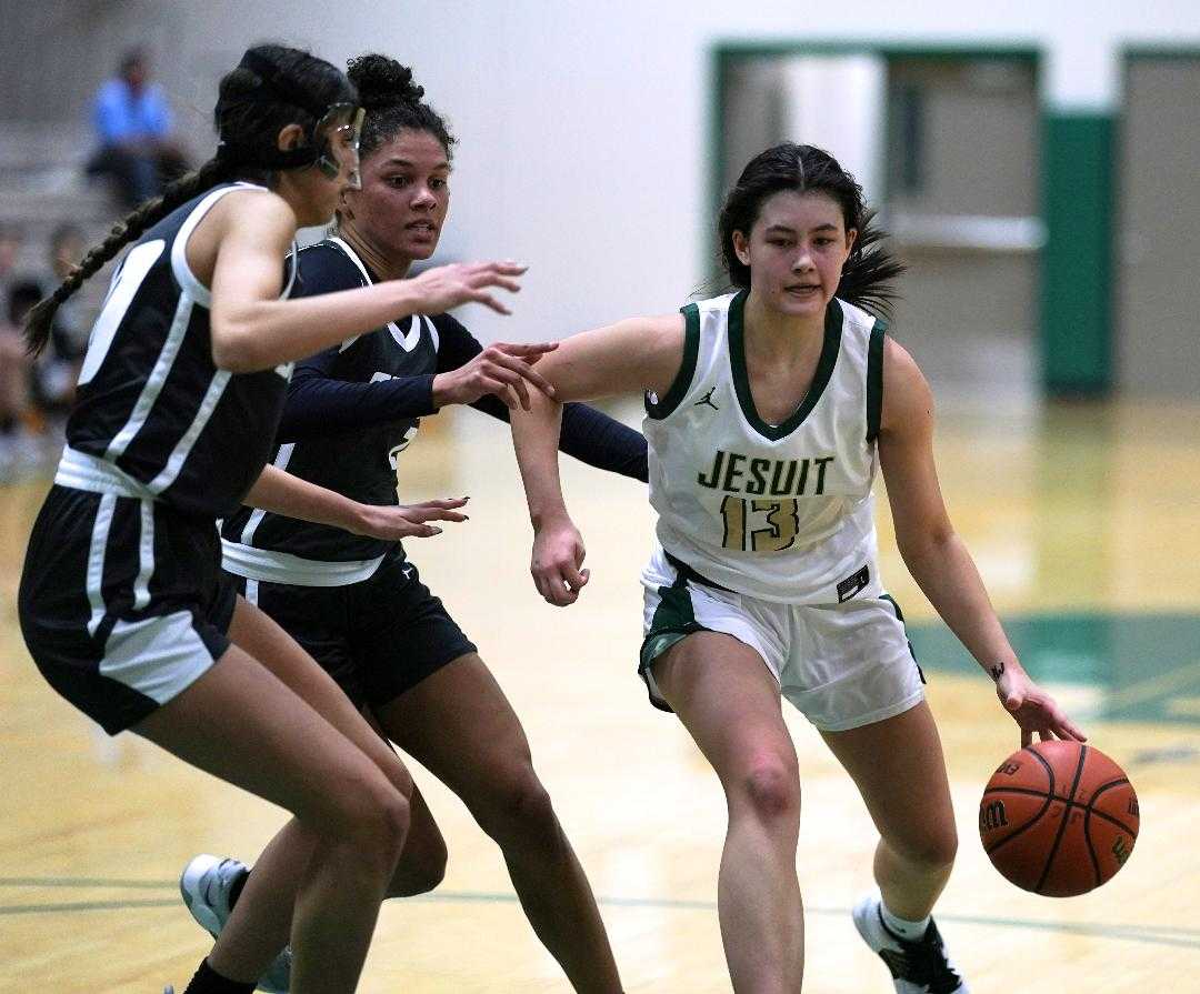 Jesuit's Emma Sixta looks to avoid the pressure of South Medford's Kim Ceron (left) and Donovyn Hunter. (Photo by Jon Olson)