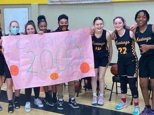 Milwaukie's Cali Denson (22) celebrates with teammates after reaching 2,000 points last week. (Photo courtesy Milwaukie HS)