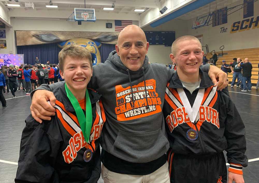 Roseburg coach Steve Lander poses between Gage Singleton, left, and Nash, his ToC champs