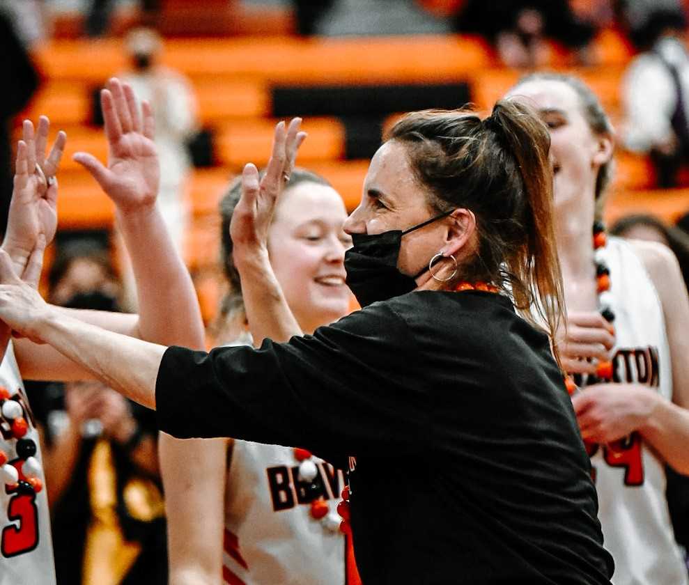 Beaverton coach Kathy Naro celebrates the Metro League title with her players Thursday night. (Photo by Fanta Mithmeuangneua)