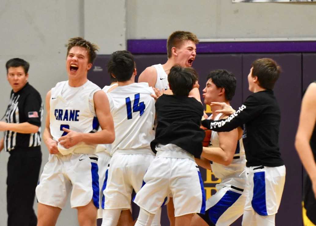 Crane freshman Cody Siegner (center), who had 11 points, celebrates with teammates. (Lisa Britton/Baker City Herald)