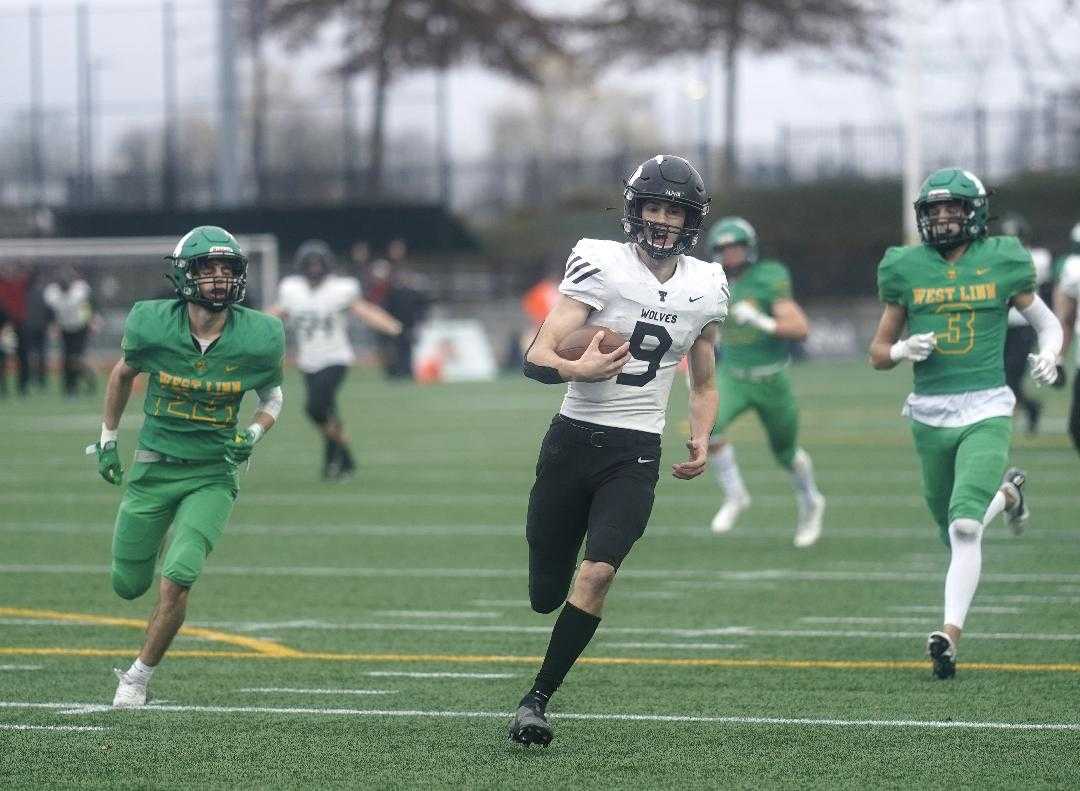 Tualatin's Jack Wagner breaks free for a touchdown run in a 6A semifinal win over West Linn last season. (Photo by Jon Olson)