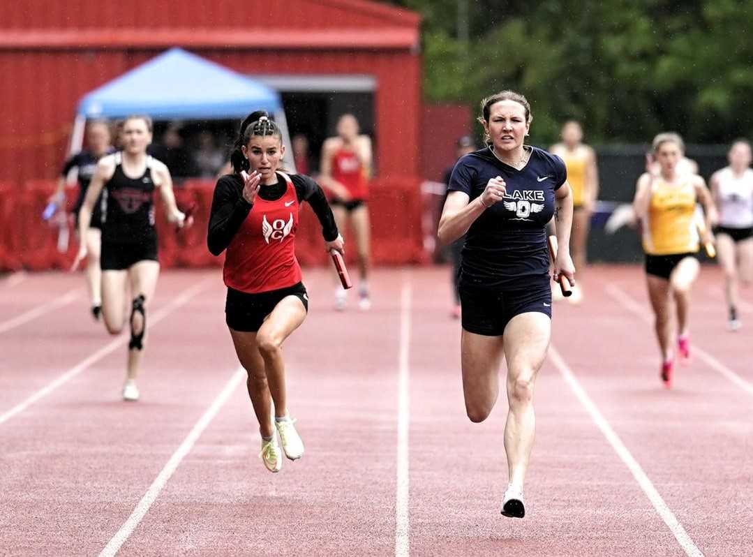 Lake Oswego's Mia Brahe-Pedersen holds off Oregon City's Harley Daniel in the Three Rivers district meet. (Photo by Jon Olson)