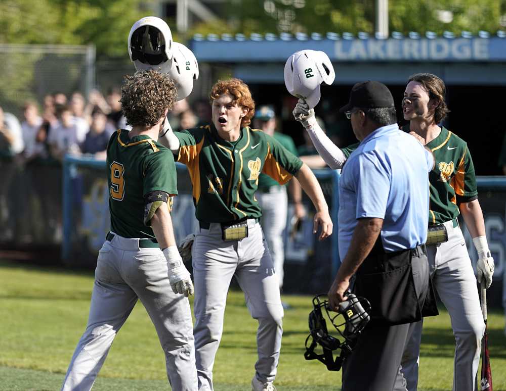Spencer Sullivan (9) celebrates his first-inning homer with West Linn's teammates Kace Naone and Max Wright (Jon Olson)