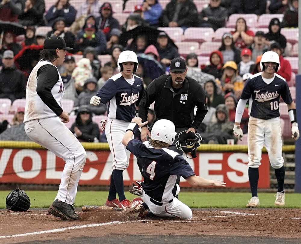 Andrew Cuff uses his legs to score for Kennedy. Cuff also used his arm and bat to propel the Trojans to 2A glory (Jon Olson)