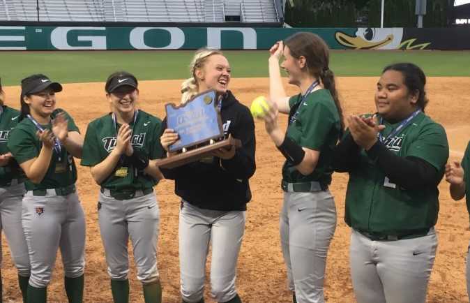 Makenna Reid (center) and Karen Spadafora (with ball) celebrate Tigard's first state championship on Tuesday night.