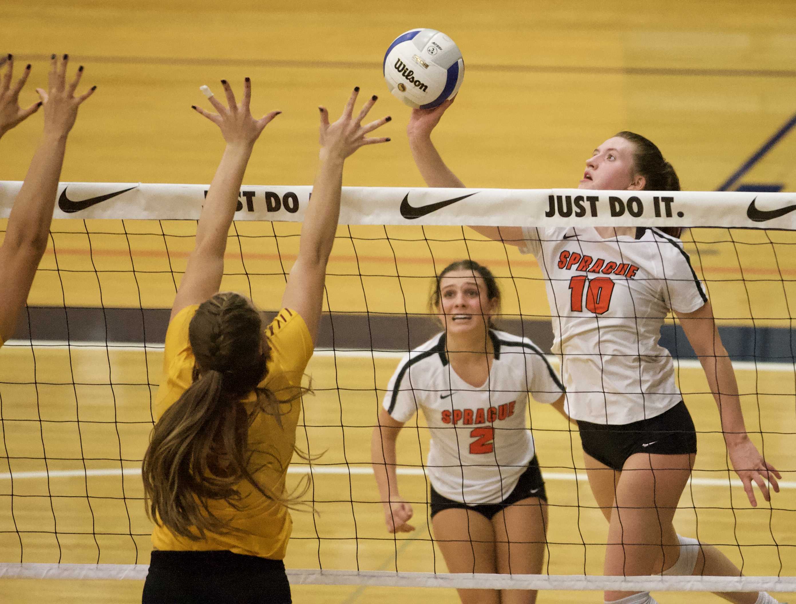 Sprague's Morgan Doll tips over a Central Catholic wall in her team's dramatic victory over the Rams. (Photo by Norm Maves Jr.)