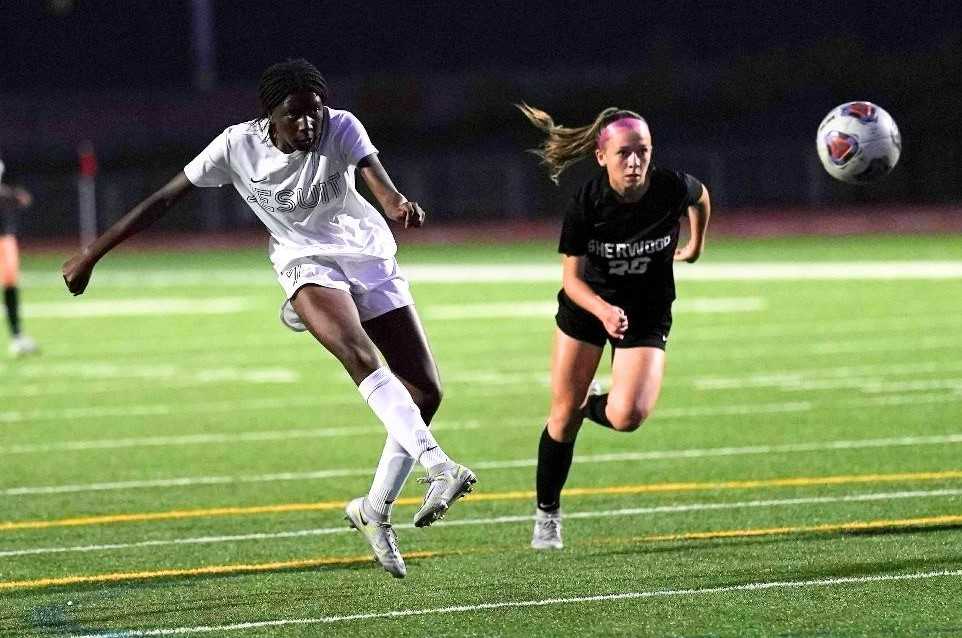 Jesuit's Makende Stewart, who scored twice Monday, goes against the defense of Sherwood's Caroline Fischer. (Photo by Jon Olson)