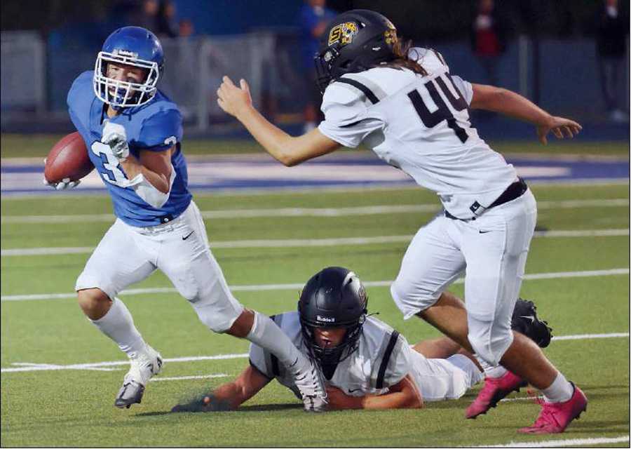 Woodburn RB/DB Ty Beyer (with ball) had 20 tackles last week. He has 45 tackles for the season, which ranks second statewide