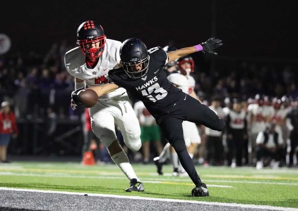 Nelson's Reid Gray beats Clackamas' Cooper Beltz into the end zone in Friday's 42-35 overtime win. (Photo by James Doane)