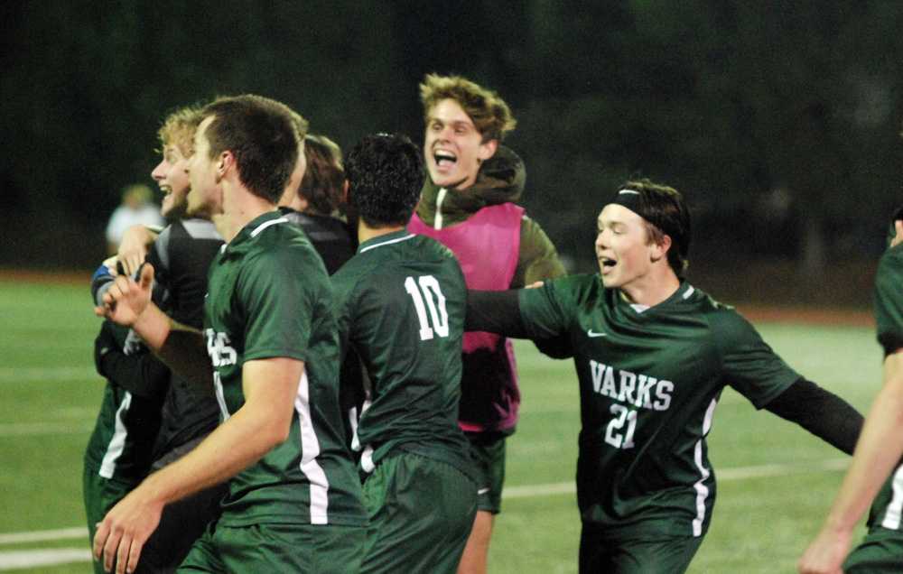 Colson Tubbs (21) and OES celebrates a hard-fought state title after withstanding a frenzied Mac-Hi finish