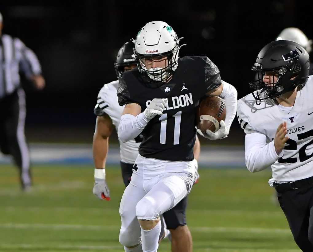 Sheldon's Grafton Robinson (11) runs from Tualatin's Calvin Evans (22) in Friday's semifinal. (Photo by Andre Panse)