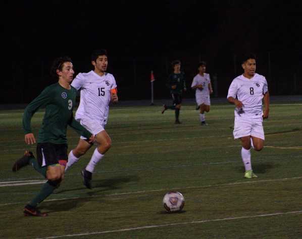 Summit's Jace Marshall (left) pushes forward against David Douglas' Miguel Andalon Ordaz (15).