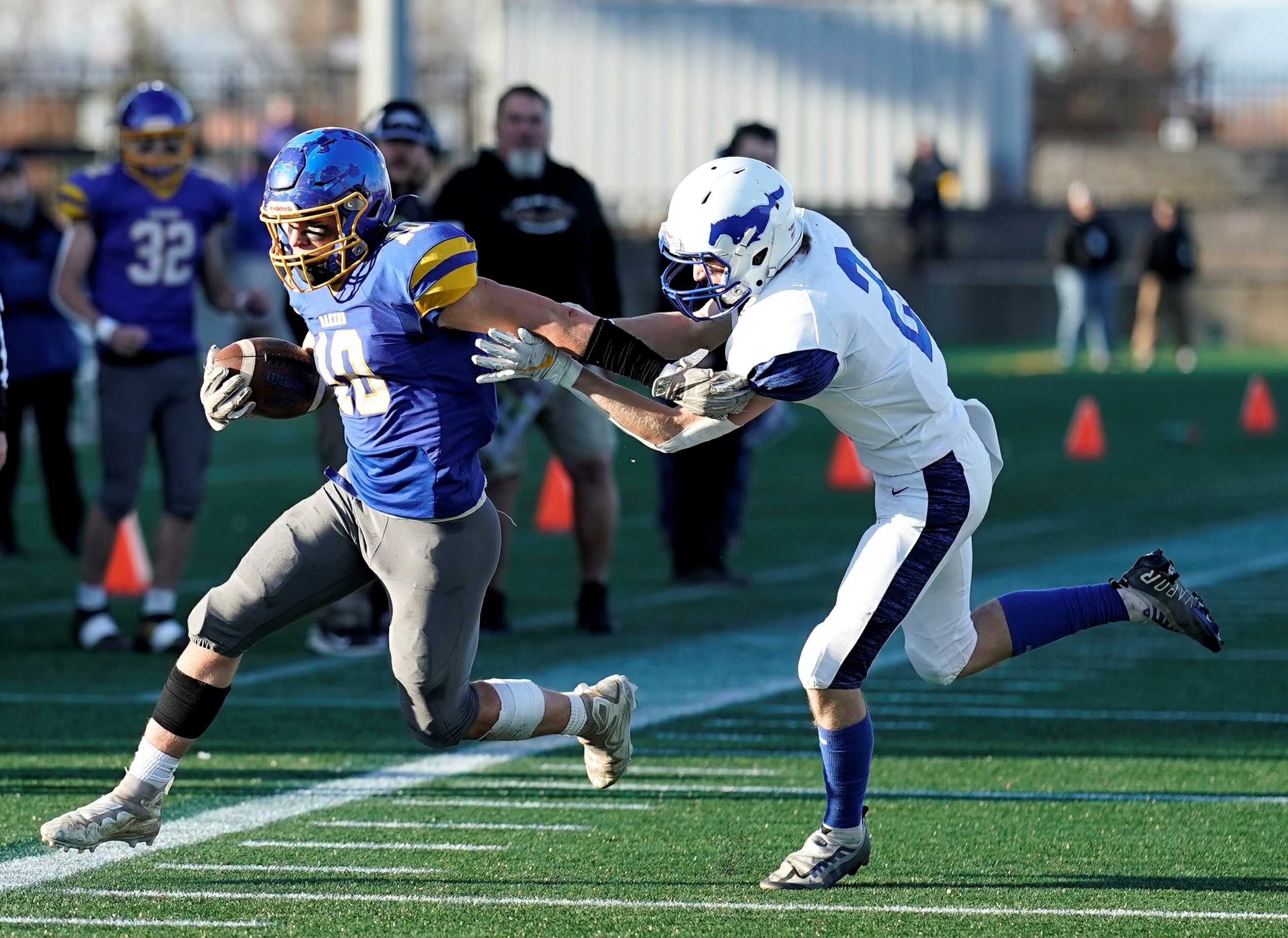 Oakland's Cade Olds (10) evades Heppner's David Cribbs in Saturday's 2A semifinal at Hillsboro Stadium. (Photo by Jon Olson)