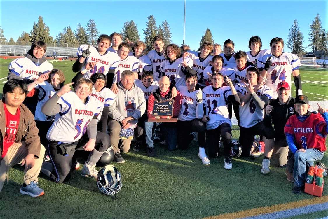 Spray/Mitchell/Wheeler players celebrate with their state championship trophy Saturday at Caldera.