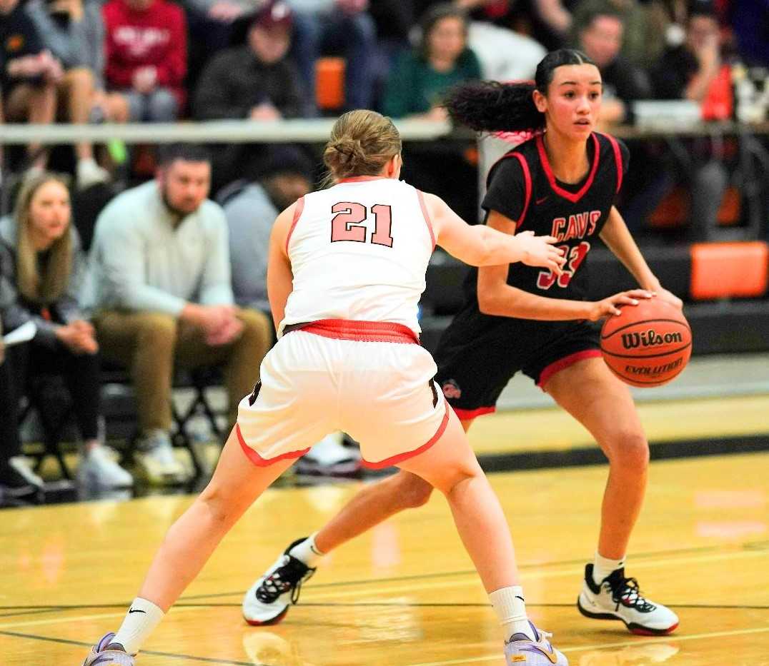 Clackamas' Jazzy Davidson works around the defense of Beaverton's Faith Meyer (21) on Wednesday. (Photo by Jon Olson)