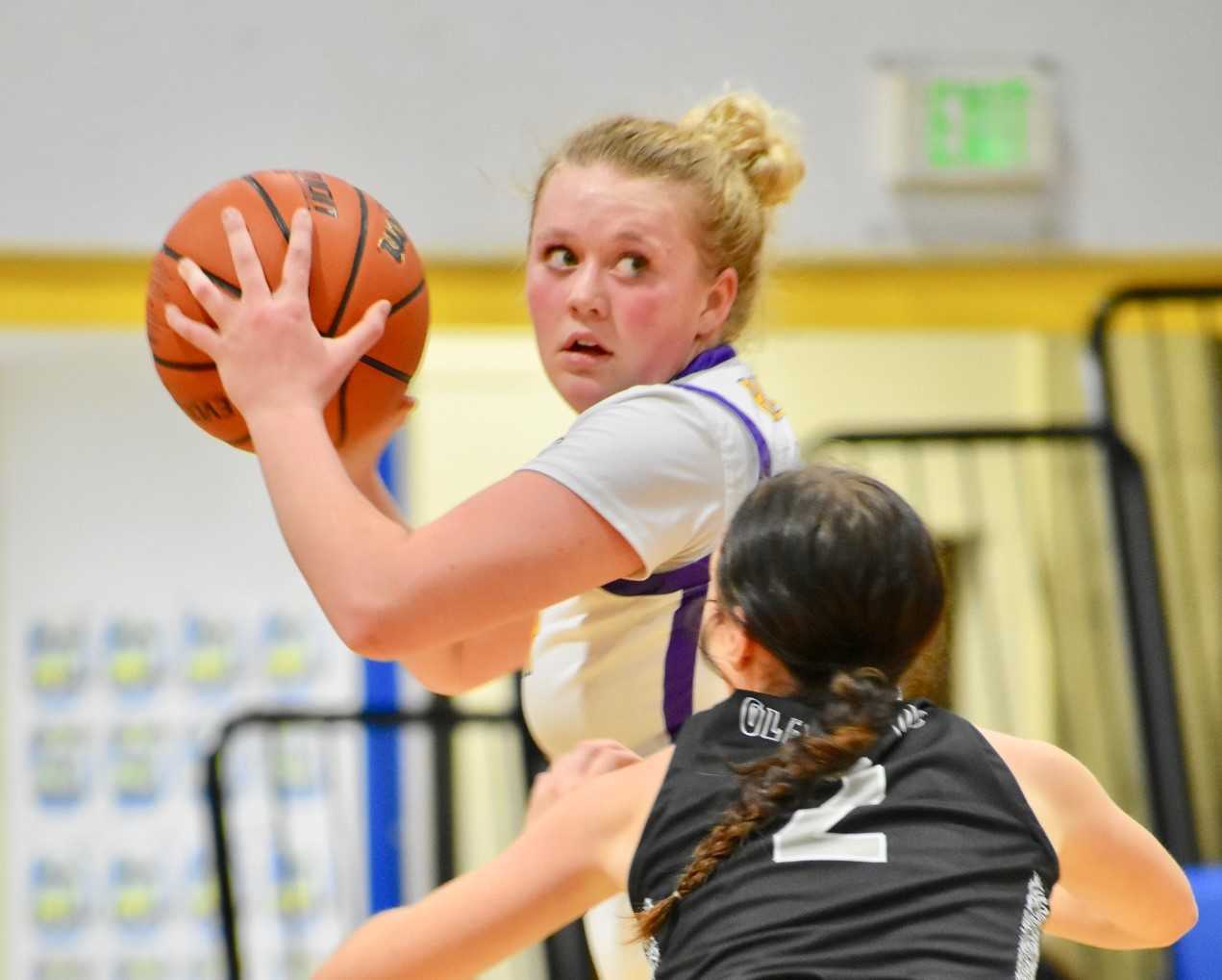 Baker's Macey Moore is guarded by Gladstone's Ryme Jaekel on Wednesday at Stanfield. (Jayson Jacoby/Baker City Herald)