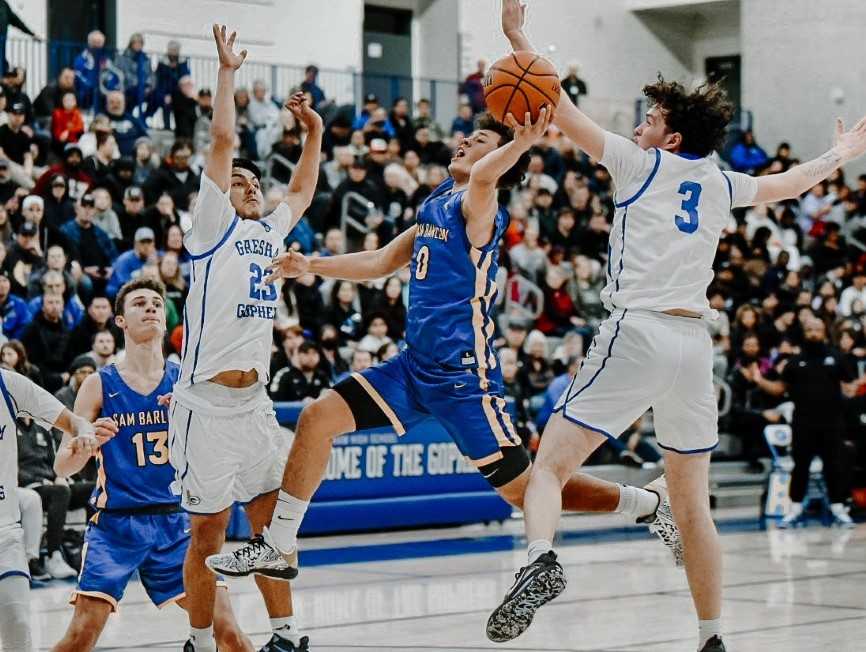 Barlow's Jalen Atkins drives between Gresham's Scotty Riddle (23) and Ulises Gutuerrez-Guzman (3). (Fanta Mithmeuangneua)