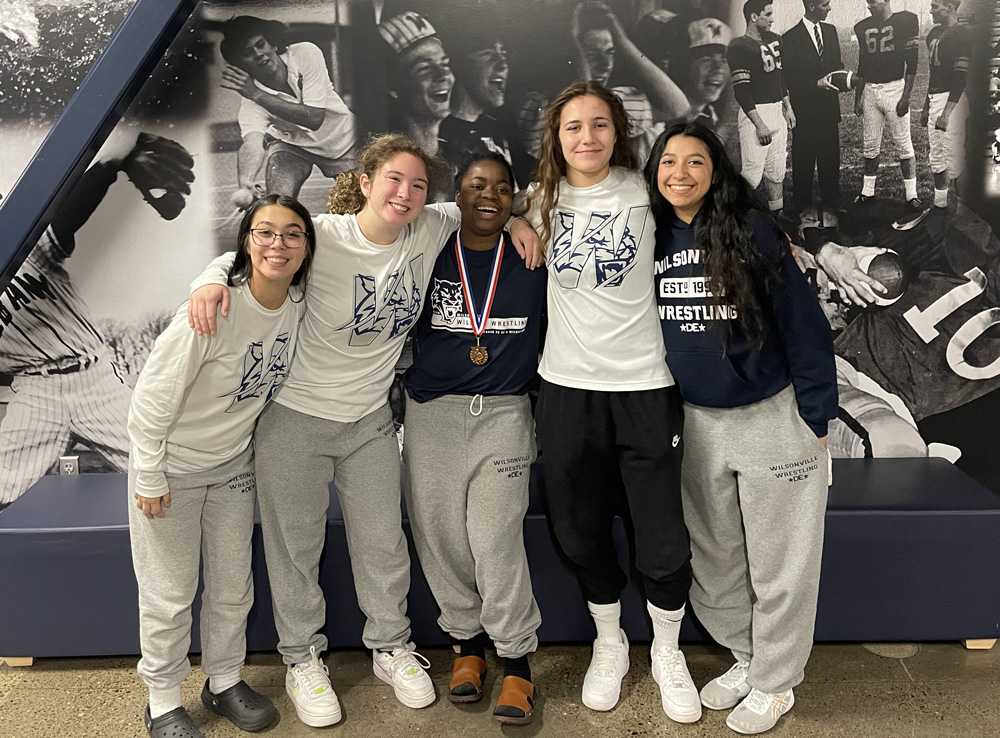 Venelle Imbi (center), surrounded by her Wilsonville teammates